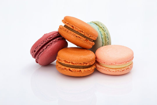 lot of colorful macarons on white background
