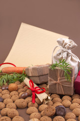 Dutch holiday Sinterklaas background with pepernoten.Traditional sweets and gifts for children for the holiday. Free space for text. Top view. Copy space. Letter and gift boxes for Saint Nicholas.