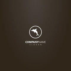 Fototapeta premium white logo on a black background. simple vector isolated logo of flat art dolphin in a round frame