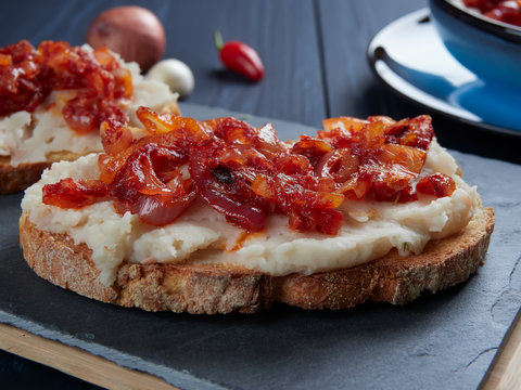 Mashed beans spread with garlic vegetable oil, with a topping of sauteed onions and tomato paste (Romanian: fasole batuta), an all-time favorite during lent and other times of religious feasting