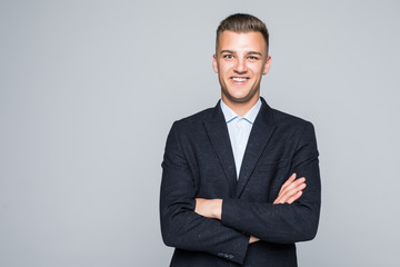 Portrait of businessman with crossed hands, isolated on white background. Concept of leadership and success