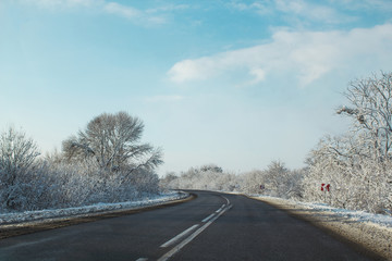Fototapeta premium Winter road ahead. Frozen landscape with empty highway