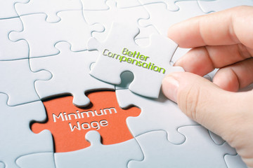 The Words Minimum Wage And Better Compensation In Missing Piece Jigsaw Puzzle