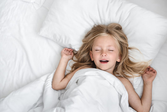 little child girl sleeping in the bed