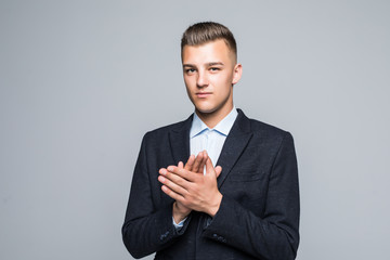 Happy young businessman standing and applauding on white background