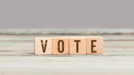 Vote word on four wood cubes