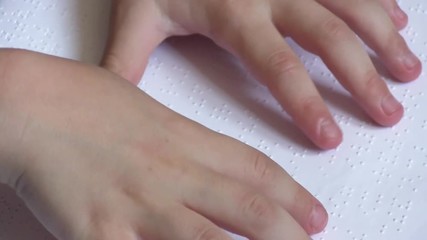 Child learning Braille alphabet at school
