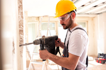 Electrician working with masonry tools