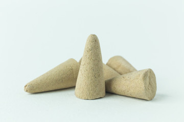 Incense Cone in a stand with the feather for background.