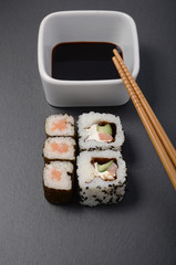 sushi rolls with soy and chopsticks
