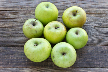 Organic apples on wooden background