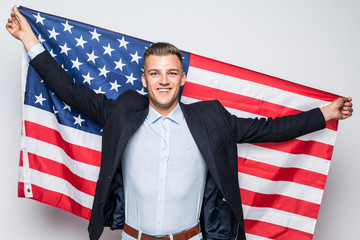 Young attractive businessman with american flag isolated on white background