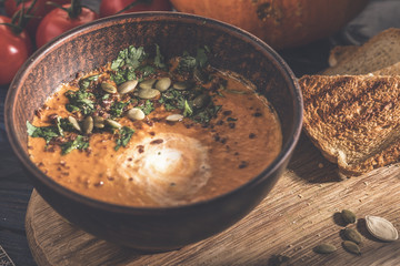 Pumpkin soup with toasts and pumpkin seeds. Toned photo