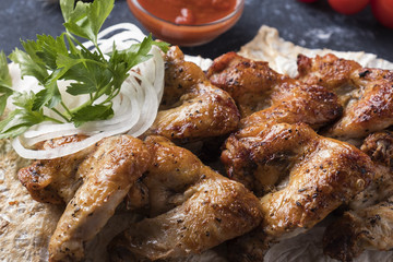 Bbq chicken wings  with red sauce. Closeup