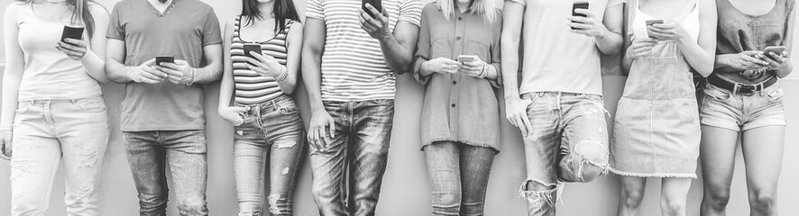 Group of teenager friends watching smart mobile phones