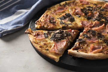 Pizza with mushroom, ham and  cheese. Italian pizza. Closeup