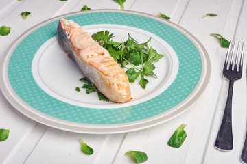 Delicious portion of salmon fillet with aromatic herbs, spices and vegetables - healthy food, diet or cooking concept