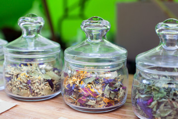 Obraz na płótnie Canvas Different Flavor Flower Tea in glass jars, Dried Flowers. Organic Herbal Tea