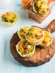 Home made healthy vegetable muffins with carrots and broccoli on wooden board. Corn breading