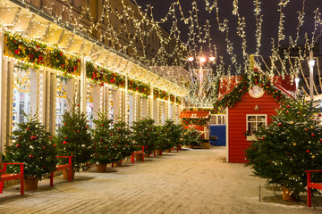 Christmas or new year decoration of city streets with Christmas trees and garlands