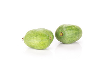 Group of two whole bright fresh green mini baby kiwi fruit isolated on white background