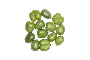 Lot of whole fresh green mini baby kiwi fruit close to each other flatlay isolated on white background