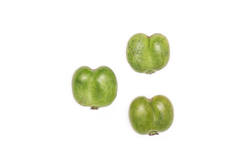 Group of three whole fresh green mini baby kiwi fruit flatlay isolated on white background