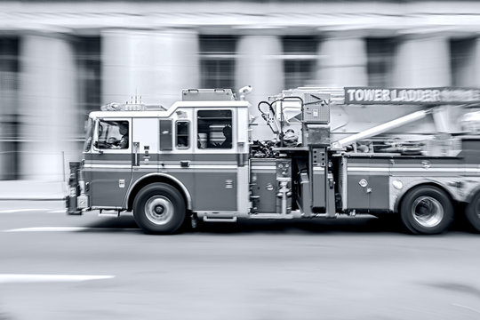 fire trucks and firefighters brigade in the city in monochrome blue tonality