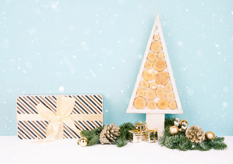 Christmas wooden tree over dark light blue background.