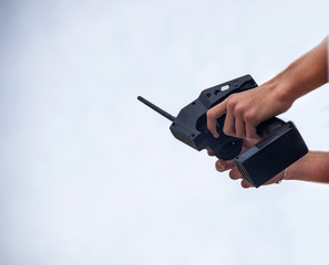 A man holds a radio-controlled remote in the hands of the car, competitions in radio-controlled...