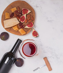 Wine and snaks on the white marble styled table