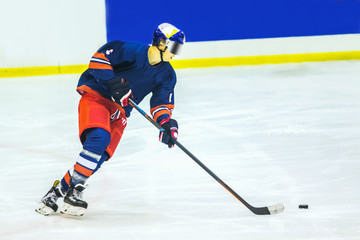 ice hockey player with puck on the ice