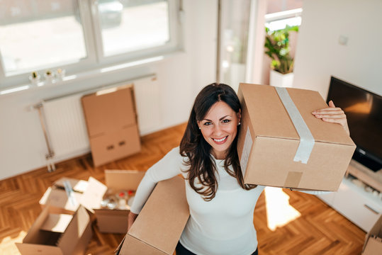 High angle image of smiling young woman moving to a new home.