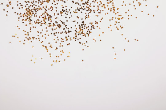 Golden glitter decor on the white background with copy space
