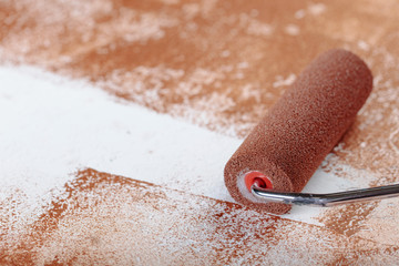 Painting roller  surface copper paint  inside in apartment close up.
