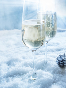 Two champagne glasses in snow
