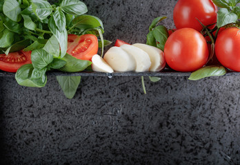 Mozzarella with basil and tomatoes .