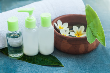 Flowers , towel and cream tubes for relax room. Body care and spa concept