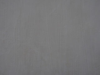 Fototapeta premium old light grey painted wall surface with textured brush marks and faint cracks full frame background