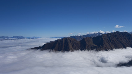 Peaks of mountains with clouds around