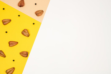 Creative and minimal autumn layout. Dry leaves and seeds on pastel background, pink, ocher and...