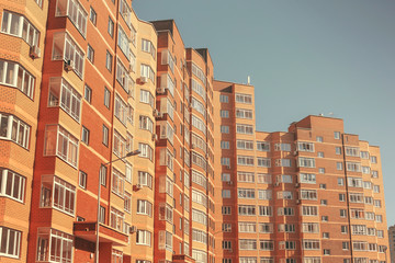 Fototapeta na wymiar Residential multi-storey building against the blue sky