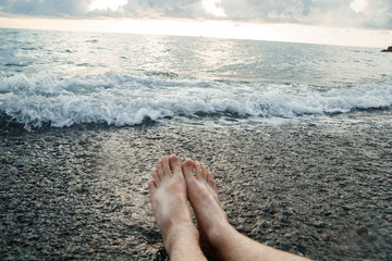 Feet in the water by the sea