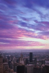 Aerial view of Manhattan skyscraper from Empire state building observation deck. Pink sunrise