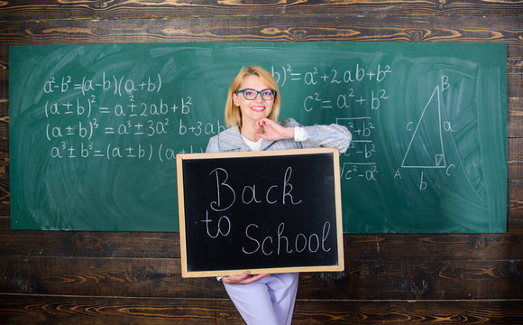 It is school time again. School teacher glad to welcome pupils. Start school year. Top ways to welcome students back to school. Teacher woman hold blackboard inscription back to school