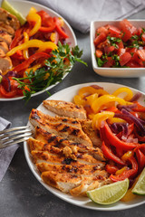 Grilled chicken fillet with sauteed peppers and onion.
