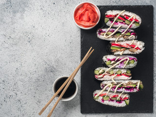 Vegan sushi sandwich onigirazu with mushrooms and vegetables.Healthy dinner recipe and idea. Colorful japan sandwich onigirazu with red cabbage,radish,cucumber,mushrooms.Trend food.Copy space.Top view