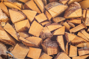 Fototapeta premium Firewood stacked. Chipped firewood. Background