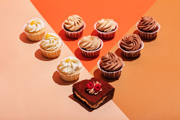Cupcake and piece of cake in a geometrical composition.