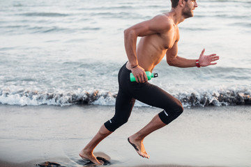 Runner Running on Sandy Beach